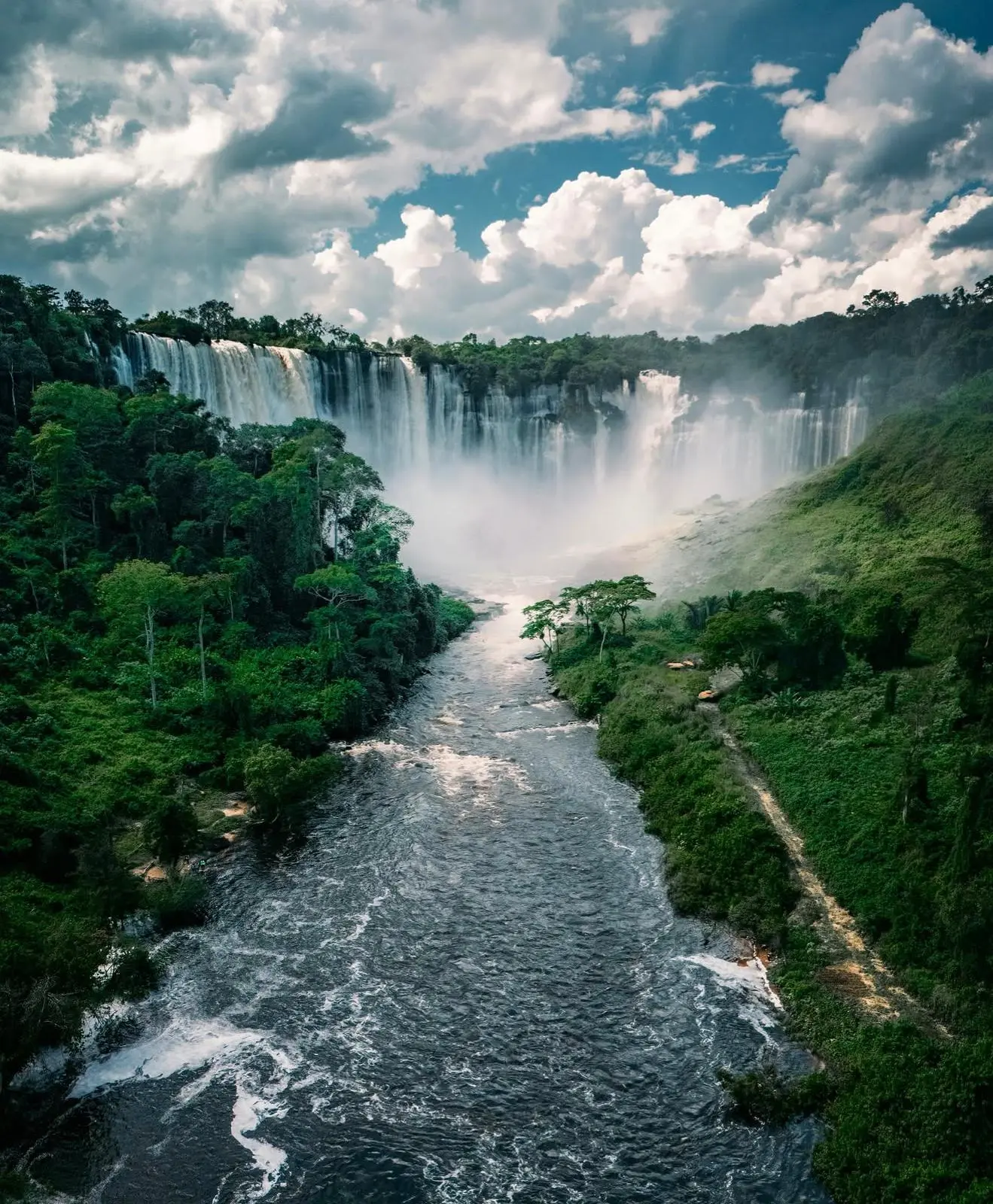 Kalandula Falls tumbling into a forested river gorge